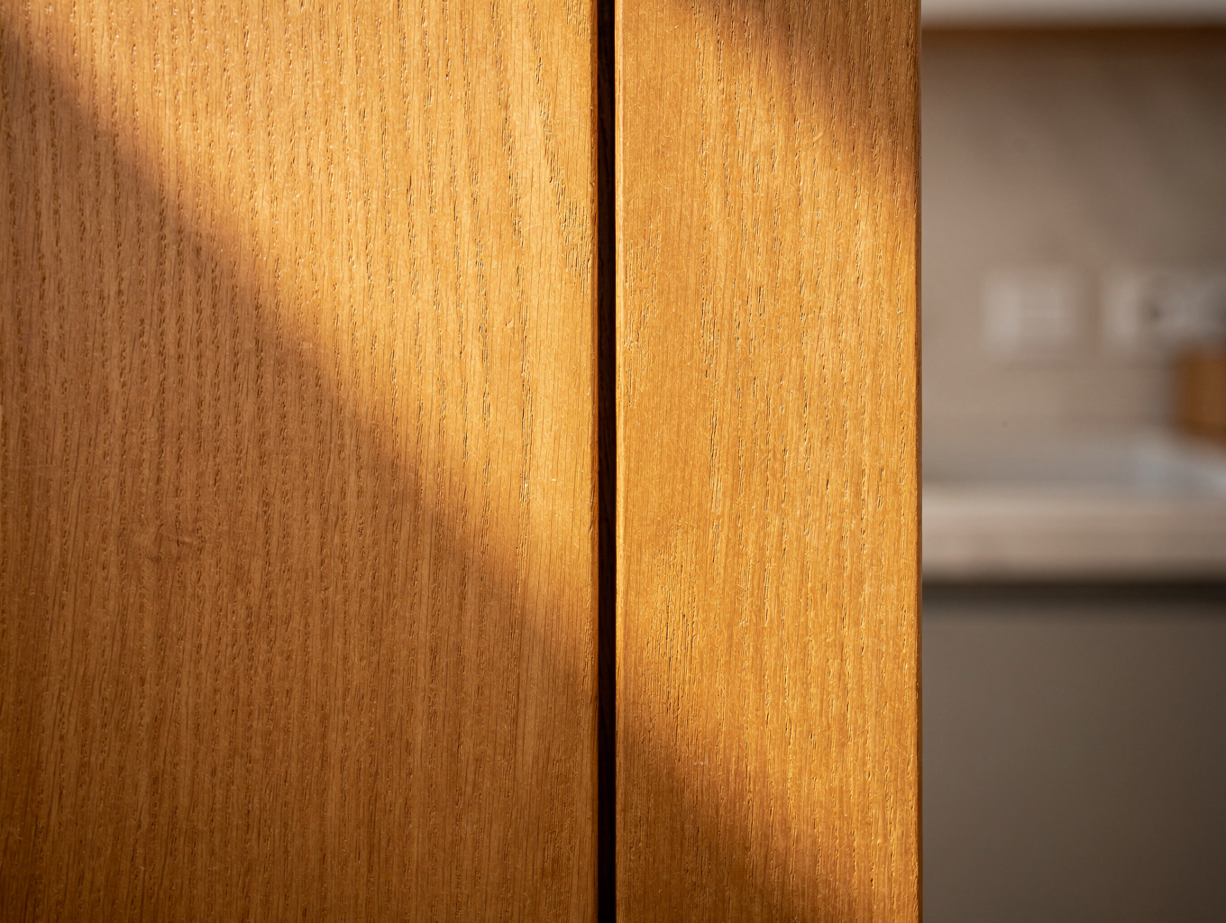 Detailed view of hand-finished natural oak cabinetry and joinery