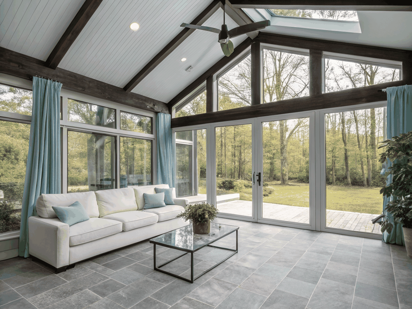 Light-filled four-season sunroom with floor-to-ceiling windows and cedar ceiling